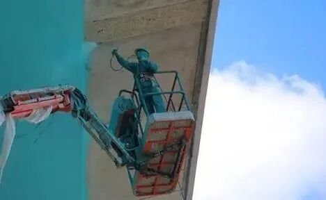 Workers spraying anti-corrosion paint on the bridge